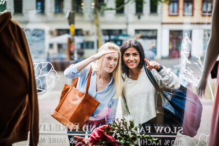 Two women looking through a shop window in Berlin 